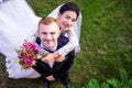 High angle portrait of happy wedding couple standing on grassy field Royalty Free Stock Photo