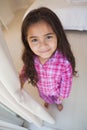 High angle portrait of a smiling girl in bedroom