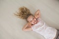 High angle portrait of a smiling girl lying on floor Royalty Free Stock Photo