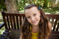 High angle portrait of smiling girl sitting on wooden bench Royalty Free Stock Photo