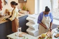 High angle two African American young women cooking together in cafe kitchen Royalty Free Stock Photo