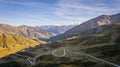 High-angle of road trails on a mountain covered with yellowing grass, sunlit, clear sky background Royalty Free Stock Photo