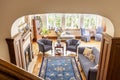 High angle of a rustical living room interior with a blue rug, armchairs, sofa and wooden floor