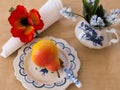 High angle selective focus still life with beautiful Bartlett pear in hand-painted plate Royalty Free Stock Photo