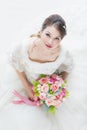 Bride sitting and holding a bouquet of flowers Royalty Free Stock Photo