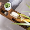 High angle shot of bathroom equipments shaving brush, hairbrush, soap, towels on a wood