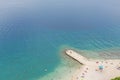 High angle shot of the beach shore with a pathway on the water in Makarska, Croatia