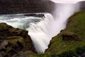 High angle shot of the beautiful Gullfoss Waterfall in Iceland cascading down a mossy cliff