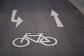 High angle shot of a bicycle sign and two arrows on the asphalt ground Royalty Free Stock Photo
