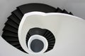 High angle shot of a black stairway going down surrounded by white walls Royalty Free Stock Photo