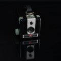 High angle shot of a black vintage brownie hawkeye camera against a black background