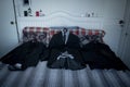 High angle shot of black wedding suits on the bed