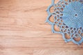 High angle shot of blue handmade crochet on a wooden surface Royalty Free Stock Photo