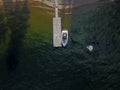 High angle shot of a boat next to a wooden pier on a lake Royalty Free Stock Photo