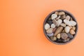 High angle shot of a bowl filled with colorful rocks and pebbles Royalty Free Stock Photo