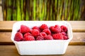 High angle shot of a bowl of fresh raspberries on a wooden surface Royalty Free Stock Photo