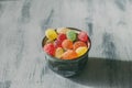 High angle shot of a bowl of jelly beans on a wooden surface