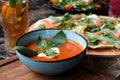 High angle shot of a bowl of tomato soup and a plate of fresh salad on a table Royalty Free Stock Photo