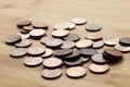 High angle shot of a bunch of coins on a wooden surface