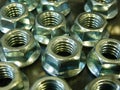 High angle shot of a bunch of metal nuts on the surface