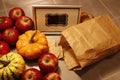 High angle shot of a bunch of red apples, miniature pumpkins and crisp bread.