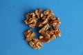 High angle shot of a bunch of walnuts on a blue background