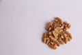 High angle shot of a bunch of walnuts on a white background