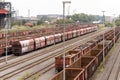 High angle shot of cargos on the train tracks captured behind a station