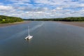 High-angle shot of a catamaran sailing boat in the river Cleddau on a sunny day