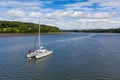 High-angle shot of a catamaran sailing boat in the river Cleddau on a sunny day