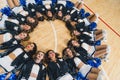 High angle shot. Cheerleading squad lying on the floor in a circle. Sport concept.