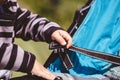 High angle shot of a child fixing his blue car seat captured on a sunny day