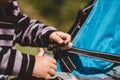 High angle shot of a child fixing his blue car seat captured on a sunny day