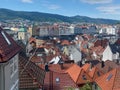 High angle shot of the cityscape of Bergen, Norway against Mount Floyen on a sunny day