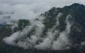 High angle shot of clouds over  mountain peak Royalty Free Stock Photo