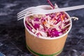 High angle shot of a coleslaw salad with a fork