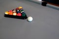 High-angle shot of colorful billiard balls in the triangle rack put on the gray billiard table Royalty Free Stock Photo