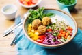 high angle shot of colorful falafel bowl with grains