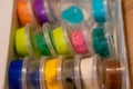 High angle shot of colorful play doughs in small packs in a box