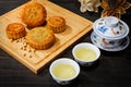 High angle shot of cookies and cups of herbal tea on a wooden surface