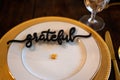 High-angle shot of corn kernel with a "grateful" black chocolate text on an empty plate