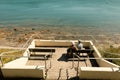 High-angle shot of a couple on a bench looking at the scenic view of Falmouth Coastline, UK