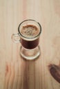 High angle shot of a cup of Cappucino on a wooden surface Royalty Free Stock Photo