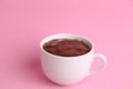 High angle shot of a cup of hot chocolate isolated on a pink surface Royalty Free Stock Photo