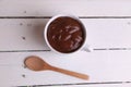 High angle shot of a cup of hot chocolate isolated on a white wooden surface Royalty Free Stock Photo