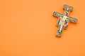 High angle shot of a decorated cross isolated on an orange background