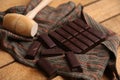 High angle shot delicious dark chocolate on a cloth on a wooden surface