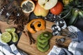 High angle shot of different sliced fruits and cinnamon on a wooden cutting board on the table Royalty Free Stock Photo