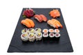 High angle shot of different sushi rolls on a black tray isolated on a white background Royalty Free Stock Photo