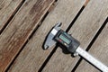 High angle shot of a digital caliper on a wooden surface Royalty Free Stock Photo